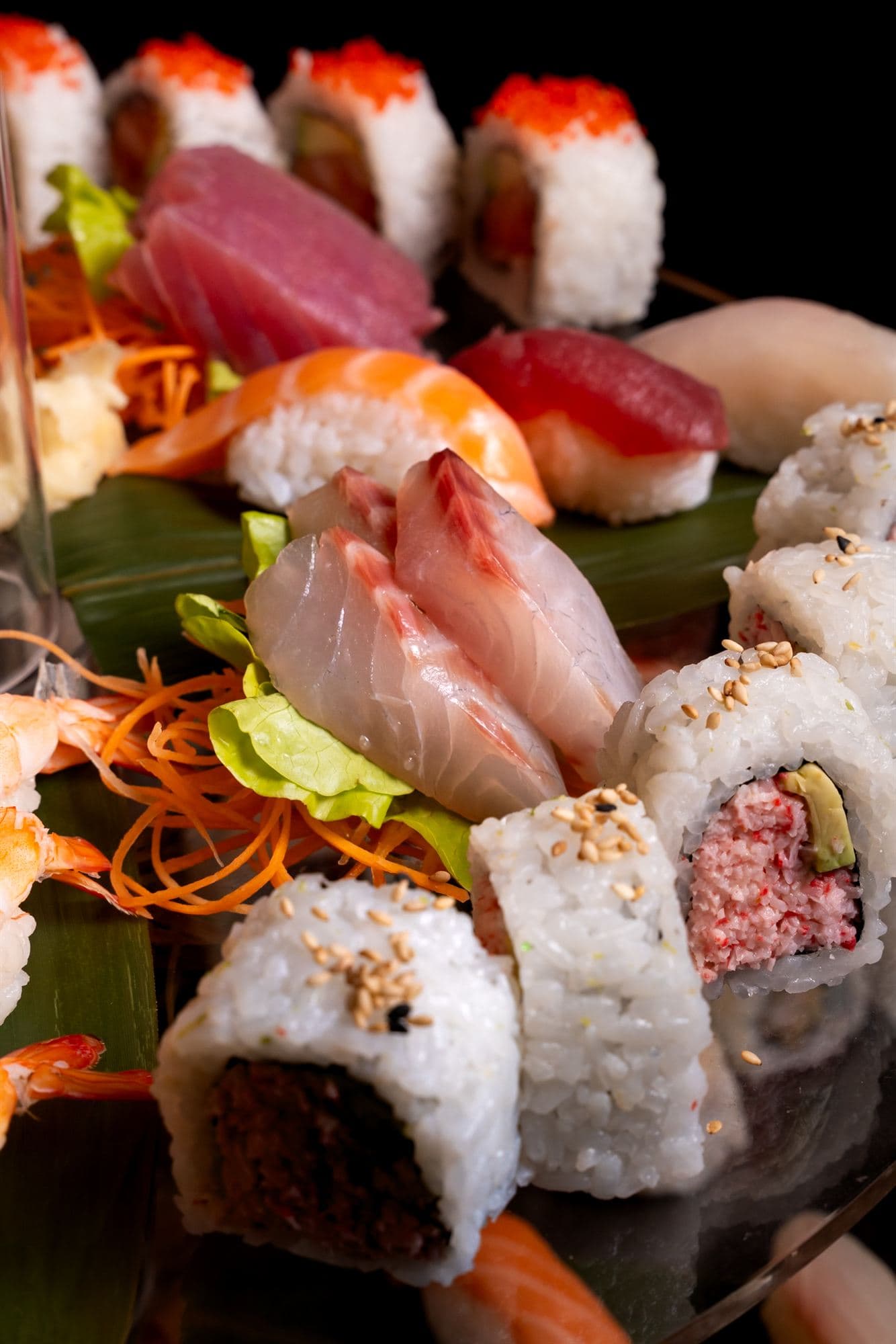 Composizione di sashimi, nigiri e uramaki su vassoio